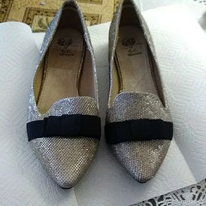 Gold colored G.C. shoes. Flats with black bow.